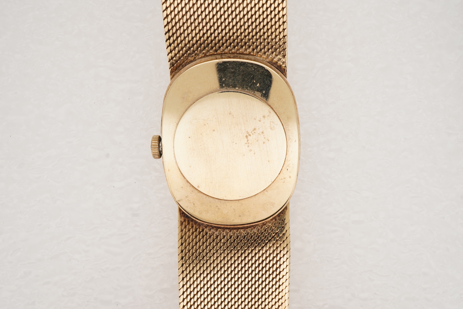 A gentleman's early 1970's 9ct gold Bueche Girod manual wind dress wrist watch, on an integral 9ct gold bark effect bracelet